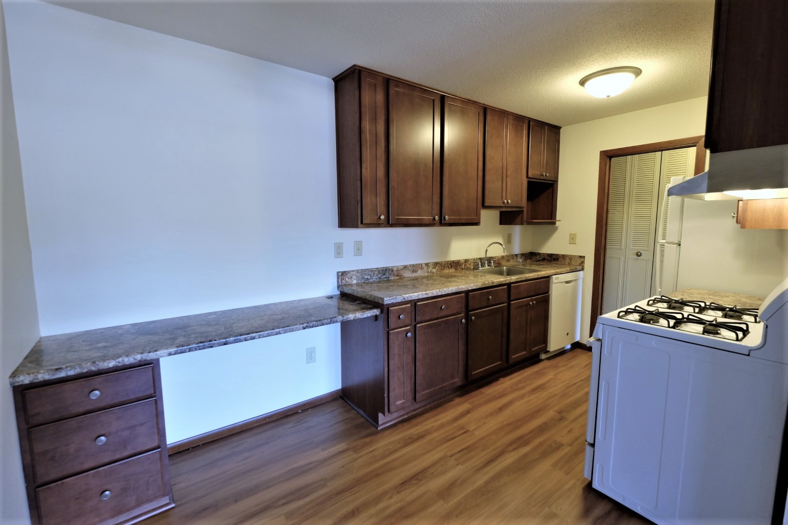 kitchen with ample counterspace and a gas range stove at Sumter Green in Crystal, MN