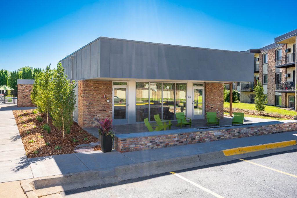 Patio Oasis With Seating And Fire Pit At Sumter Green Apartments In Crystal, MN