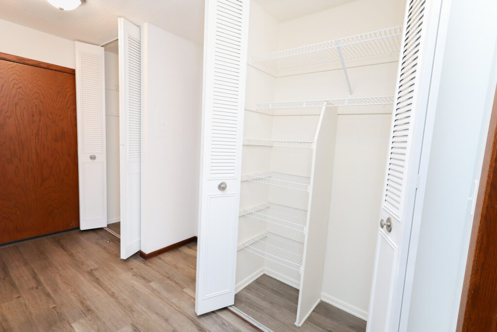 spacious closet with shelves and sliding doors