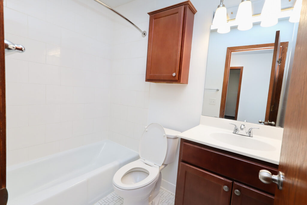 unfurnished bathroom with brown cabinets